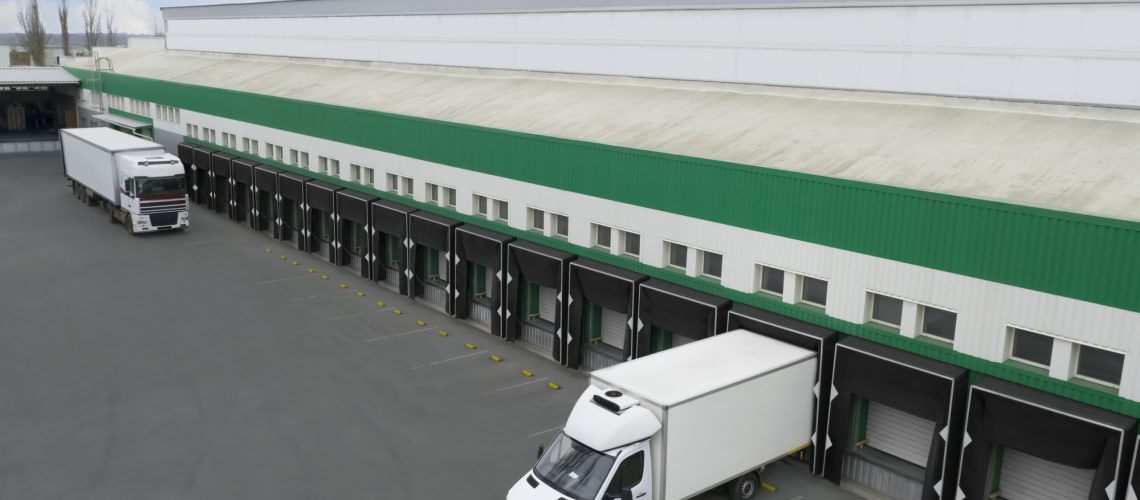 Refrigerated trucks waiting at port with delayed fresh vegetable shipments, highlighting Just-in-Time supply chain challenges and cold chain timing issues for Indian produce exports to Saudi Arabia